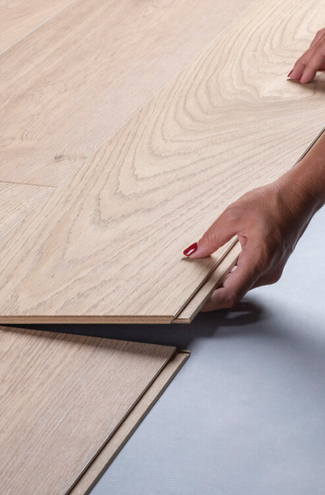 Image of a woman with red fingernail polish clicking together a hardwood floor.